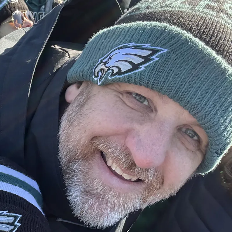 Jim Hollis smiling in an Eagles beanie at the Eagles Super Bowl parade in Philadelphia